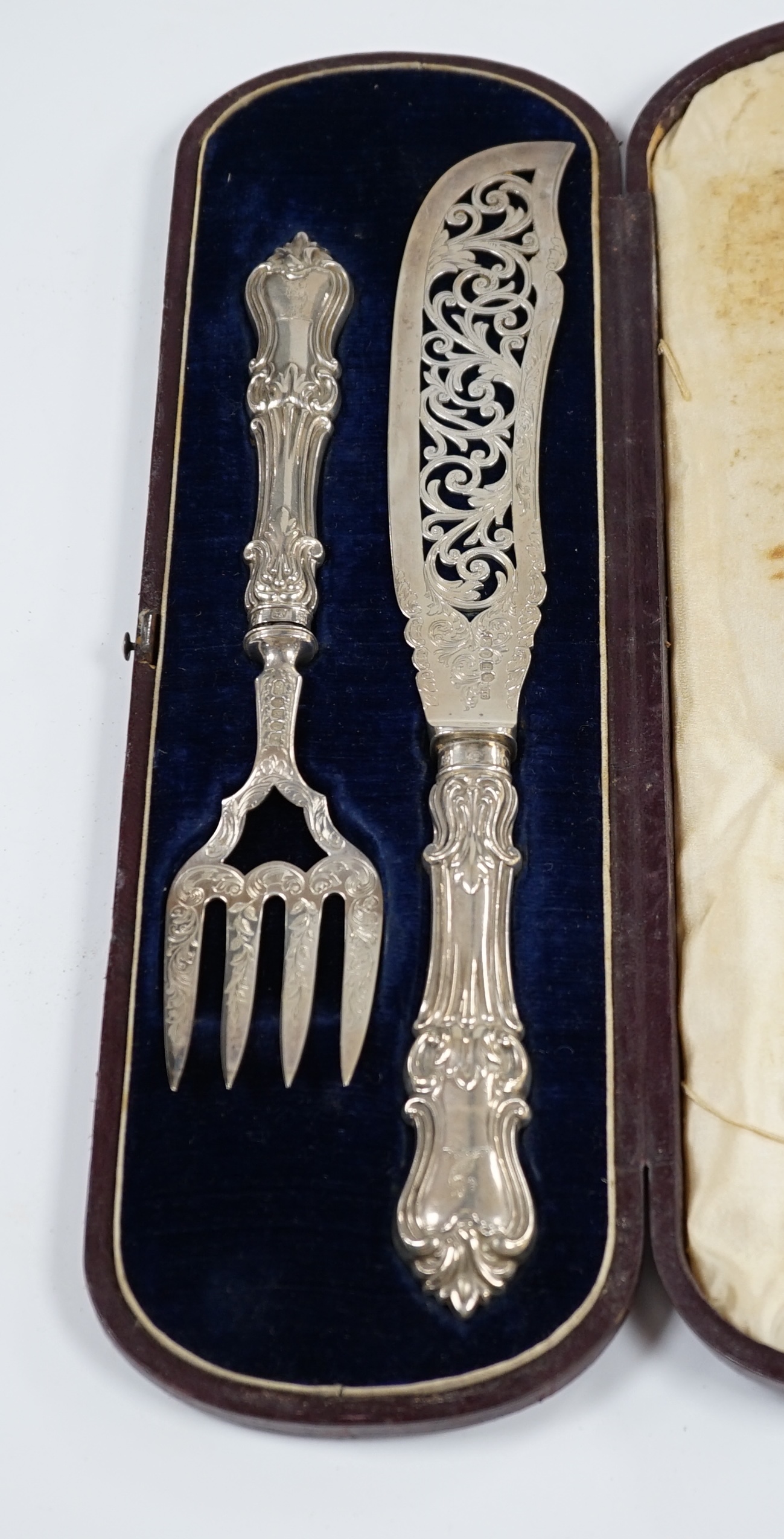 A cased pair of Victorian fish servers, by John Gamage?, Birmingham, 1850, slice 31.9cm. Condition - poor